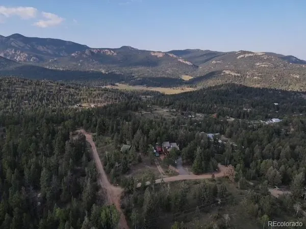a view of a mountain range with trees