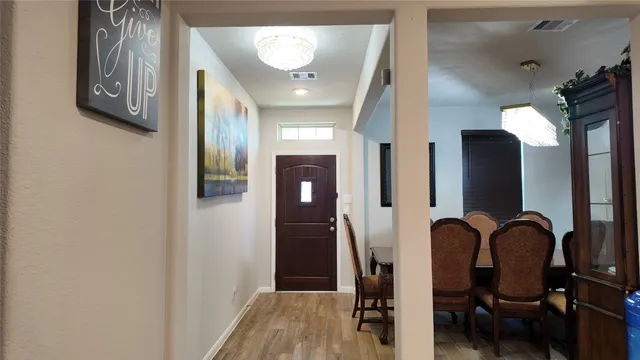 a view of a entryway with furniture and wooden floor
