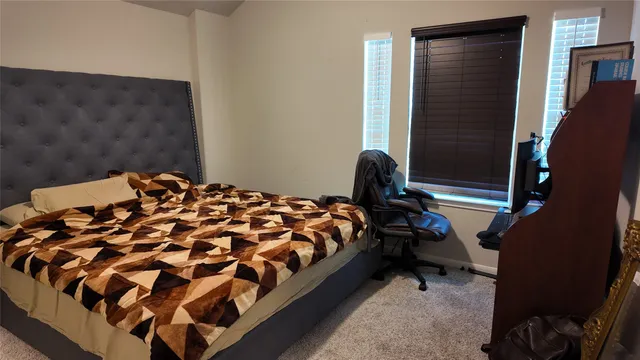 a bed sitting in a bedroom next to a window