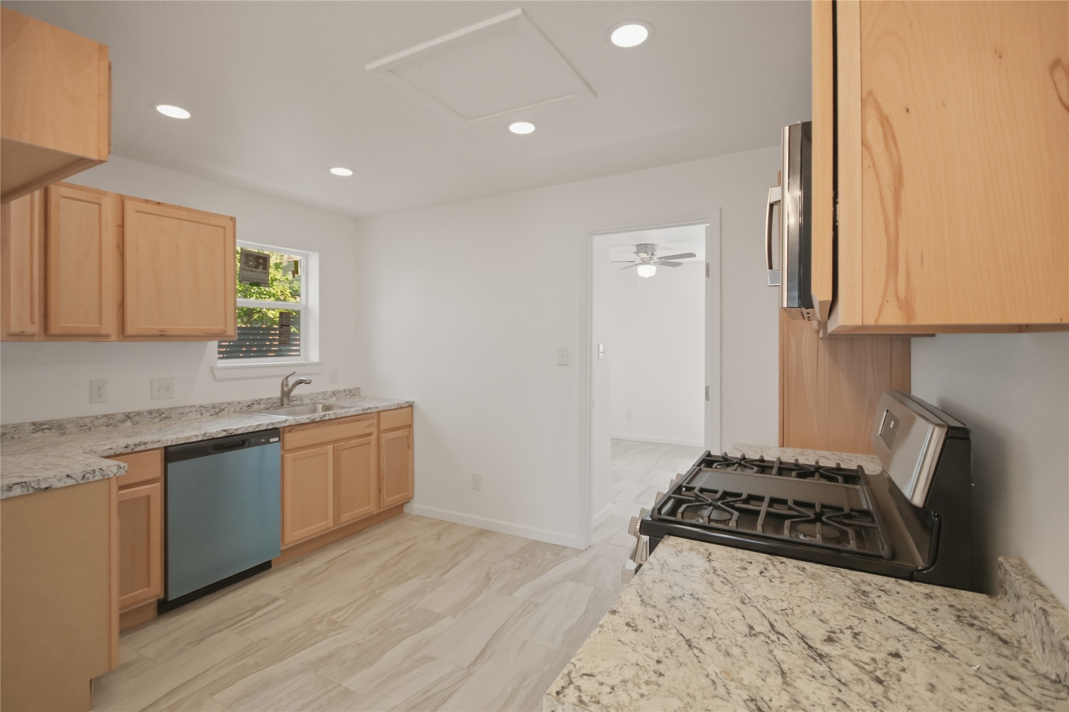 3518 Orange Street Houston, TX 77020 - Photo 11 of 27 a kitchen with stainless steel appliances granite countertop a stove and a sink