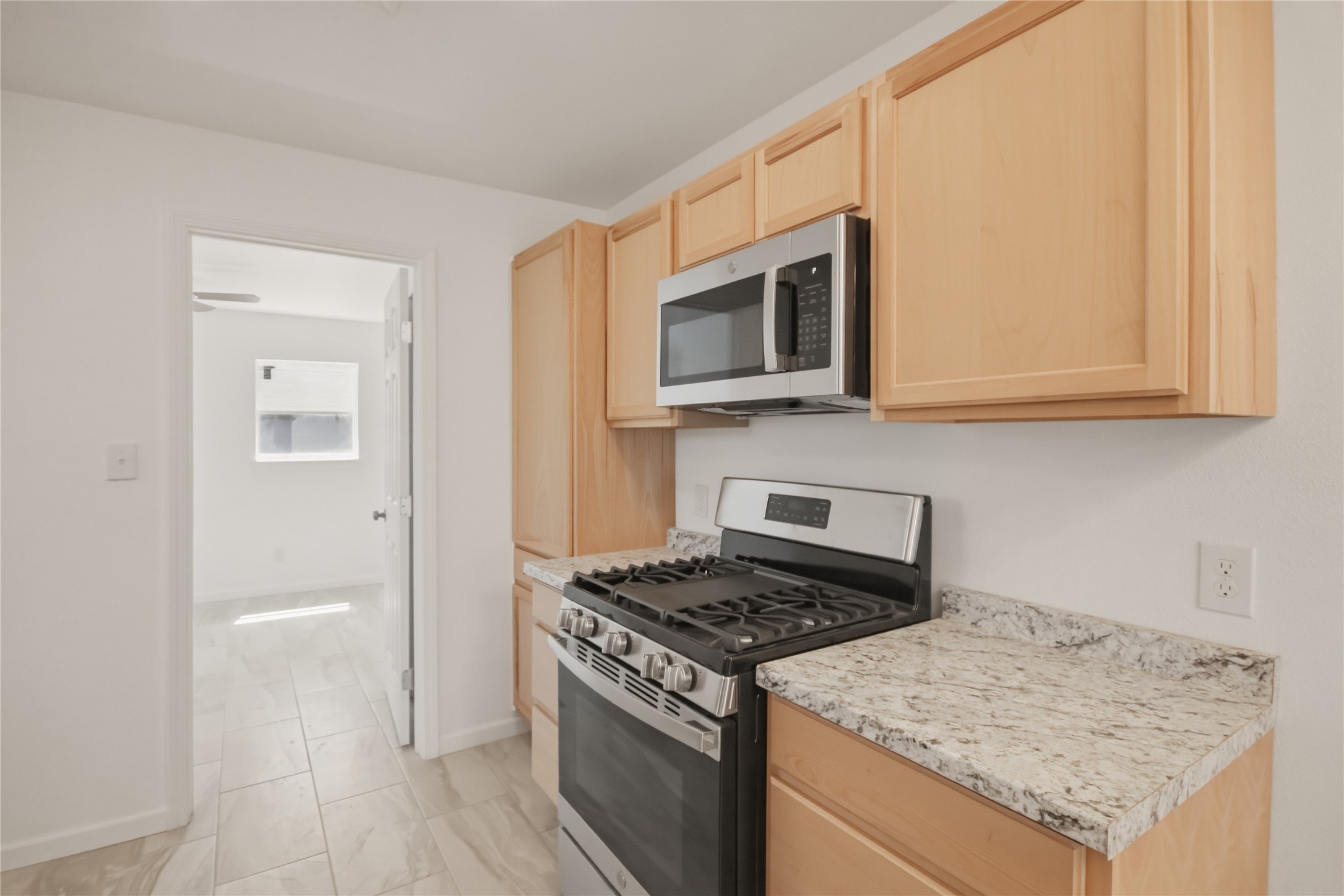 3518 Orange Street Houston, TX 77020 - Photo 12 of 27 a kitchen with granite countertop cabinets stainless steel appliances and wooden floor