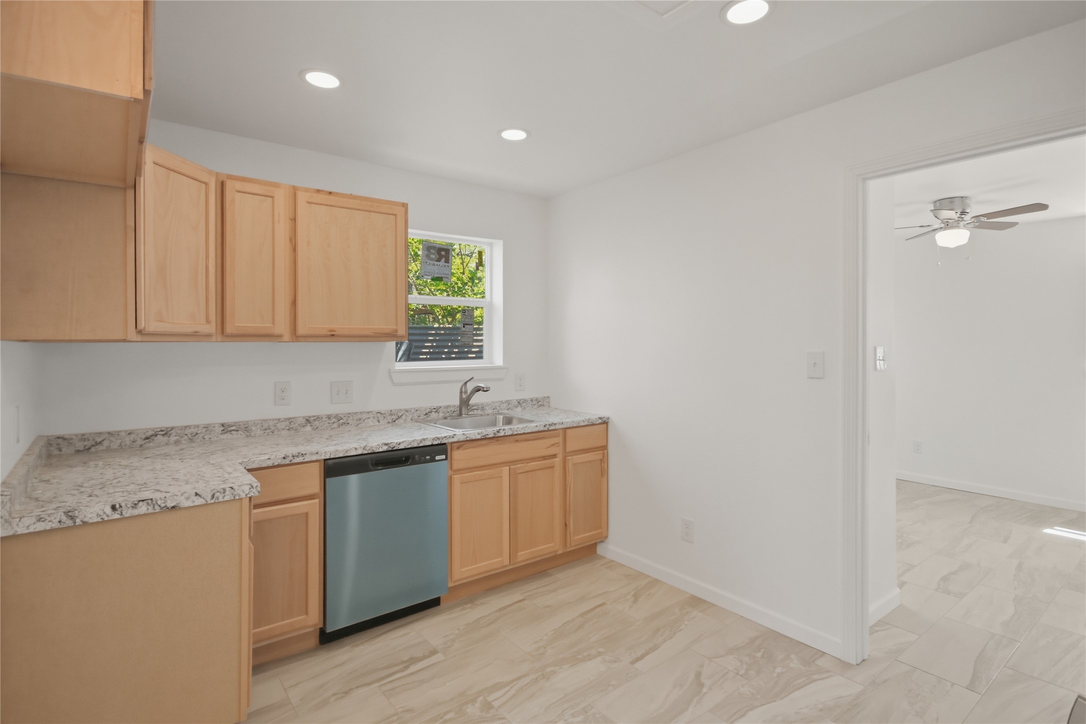 3518 Orange Street Houston, TX 77020 - Photo 13 of 27 a kitchen with a sink a window and cabinets