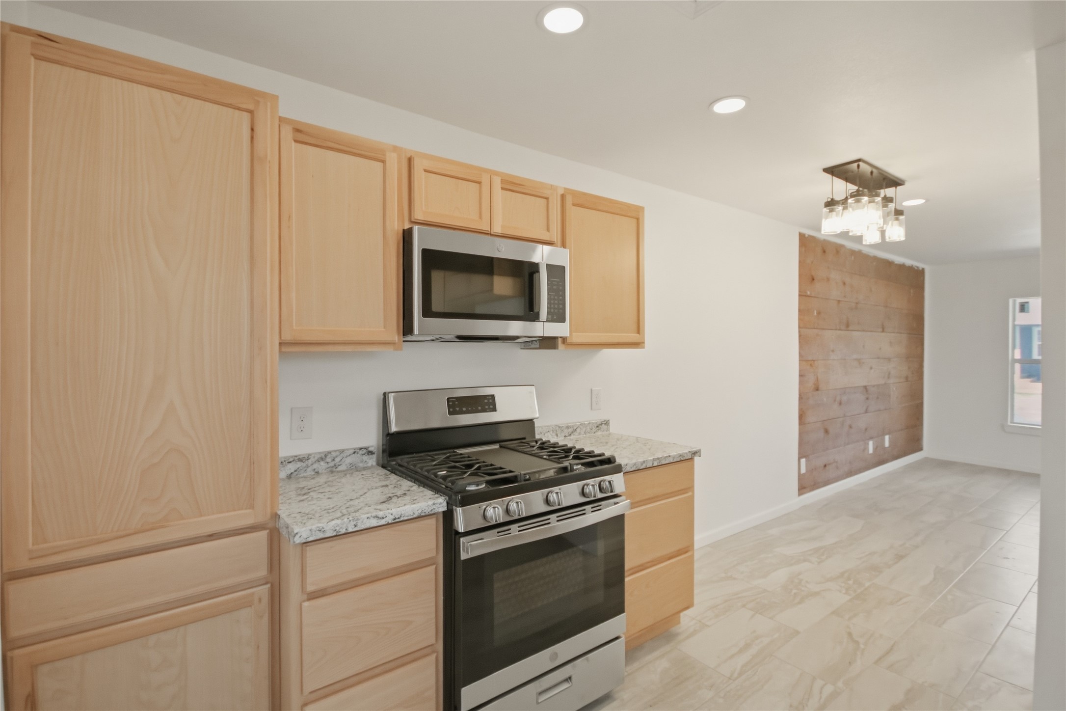 3518 Orange Street Houston, TX 77020 - Photo 16 of 27 a kitchen with a stove and a microwave
