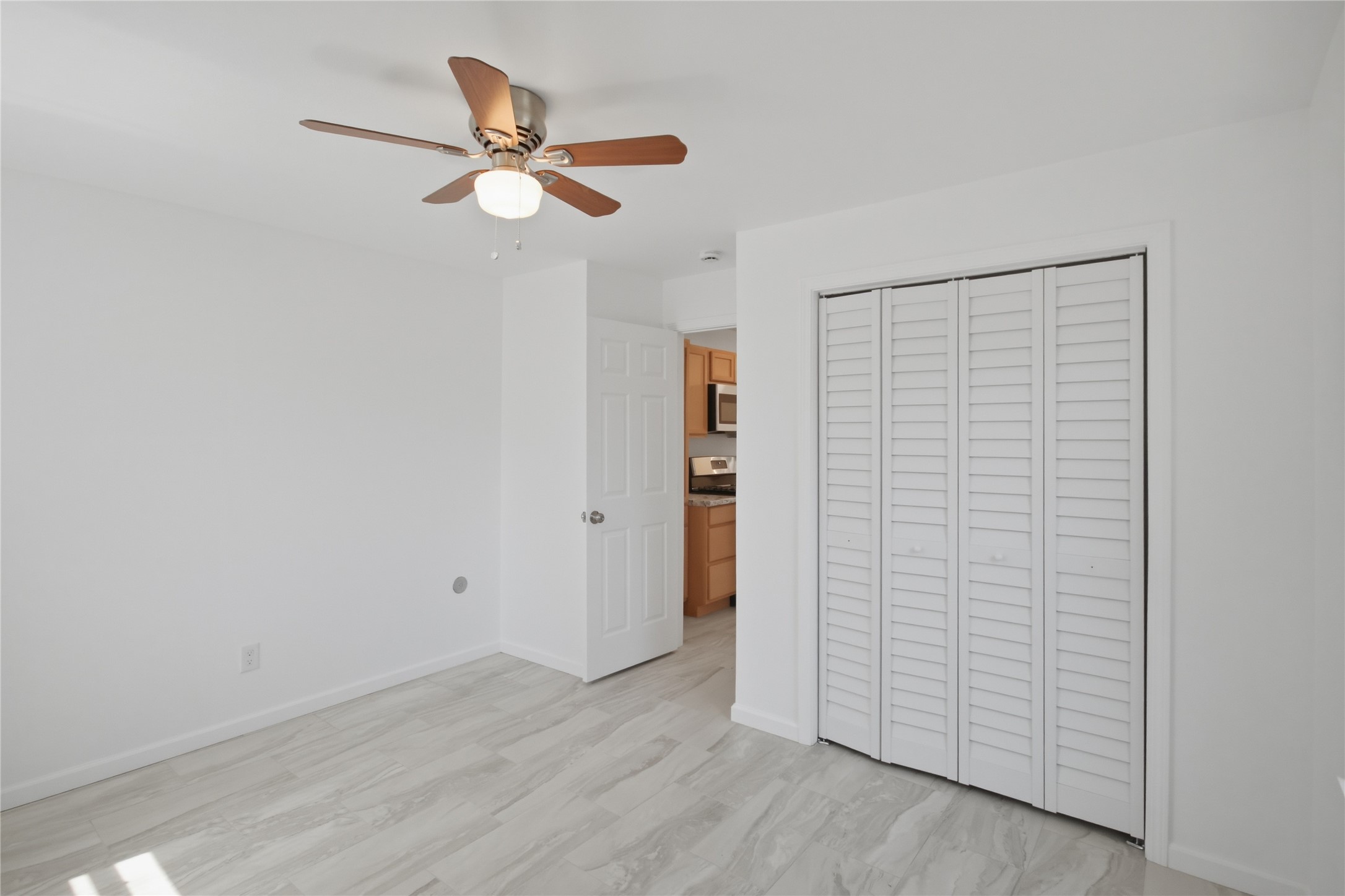 3518 Orange Street Houston, TX 77020 - Photo 21 of 27 a view of a livingroom with wooden floor and a ceiling fan