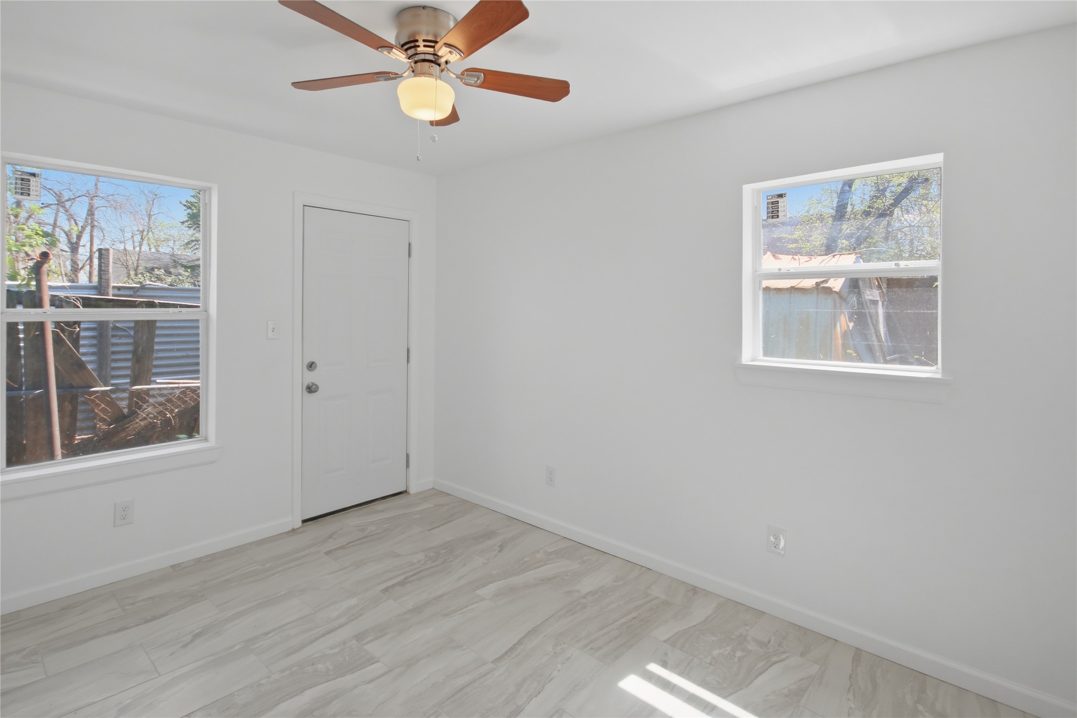 3518 Orange Street Houston, TX 77020 - Photo 23 of 27 a view of an empty room with a window and wooden floor