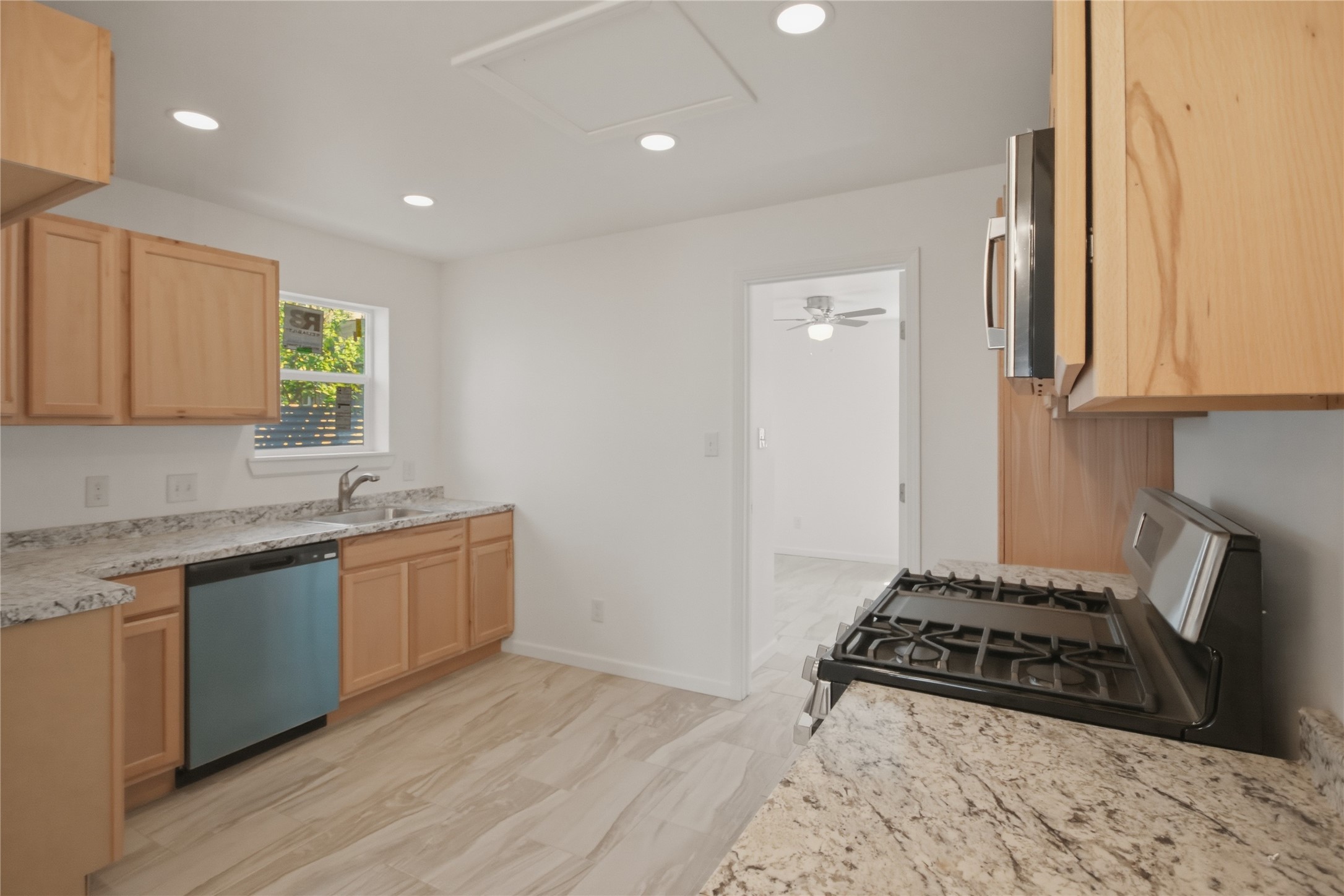 3518 Orange Street Houston, TX 77020 - Photo 10 of 27 a kitchen with sink a stove and cabinets