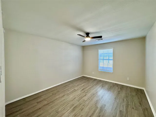 a view of an empty room and wooden floor