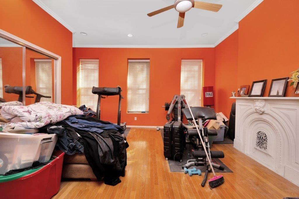 964 Gates Avenue Brooklyn, NY 11221 - Photo 11 of 25 a bedroom with furniture and a chandelier