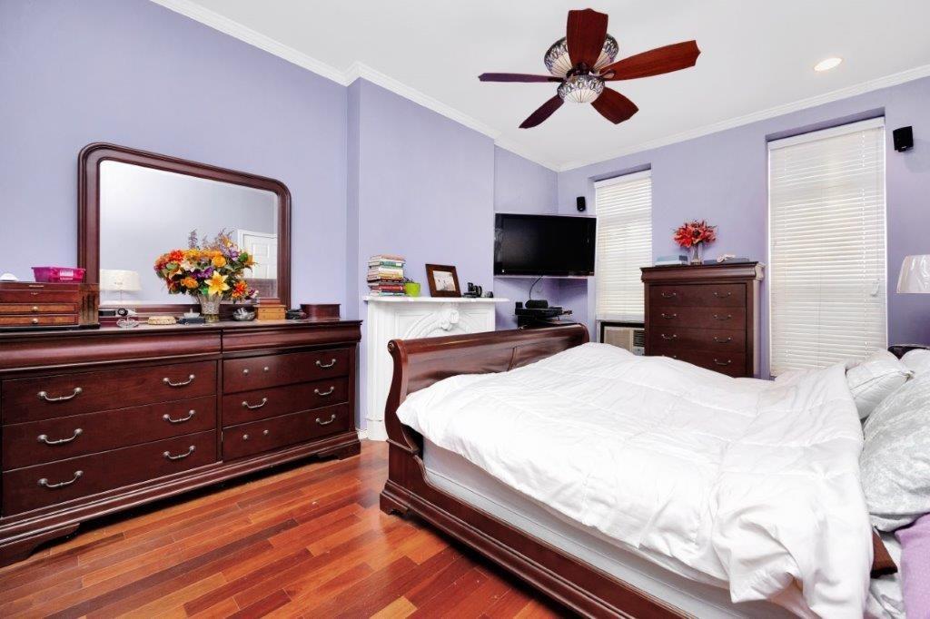 964 Gates Avenue Brooklyn, NY 11221 - Photo 14 of 25 a bedroom with a bed and a flat screen tv