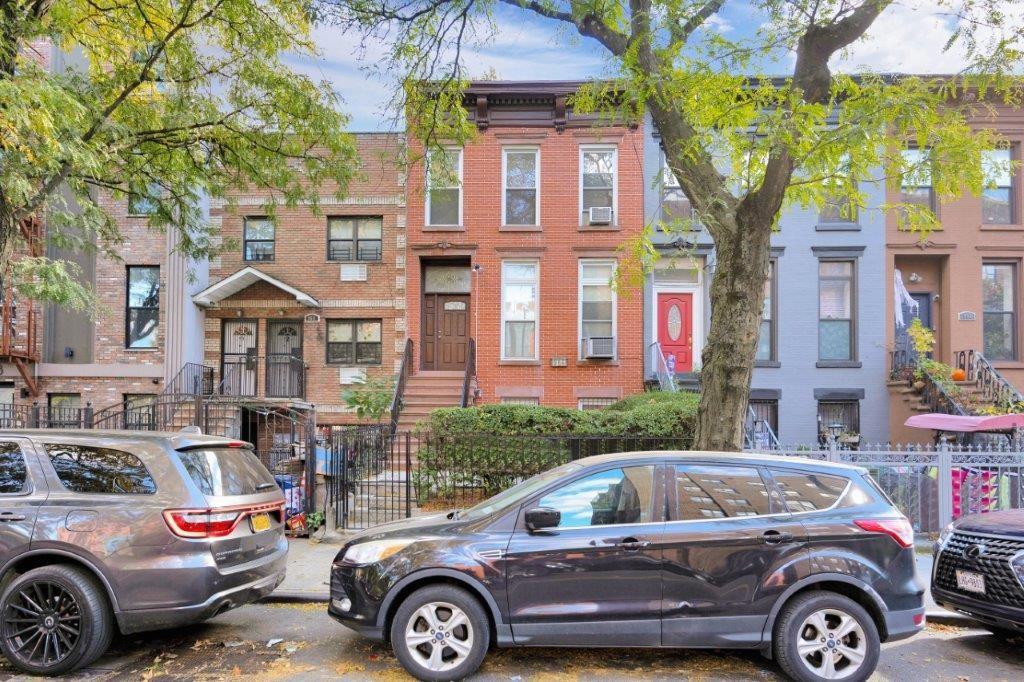 964 Gates Avenue Brooklyn, NY 11221 - Photo 23 of 25 a front view of a residential apartment building with parking space