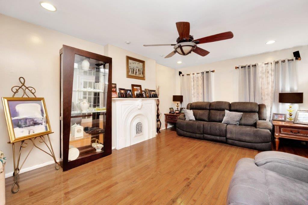 964 Gates Avenue Brooklyn, NY 11221 - Photo 4 of 25 a living room with furniture and a flat screen tv