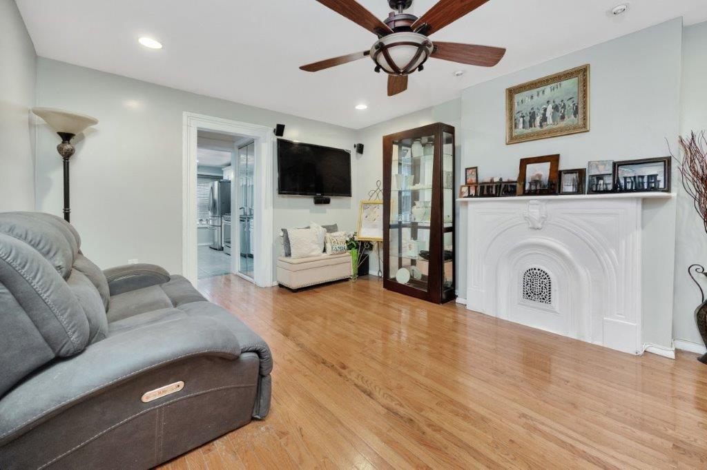 964 Gates Avenue Brooklyn, NY 11221 - Photo 6 of 25 a living room with furniture and a flat screen tv