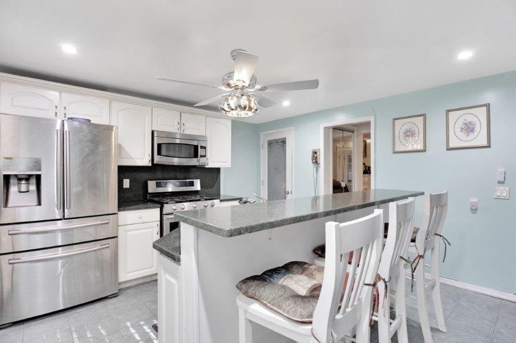 964 Gates Avenue Brooklyn, NY 11221 - Photo 8 of 25 a kitchen with stainless steel appliances a stove refrigerator sink and microwave