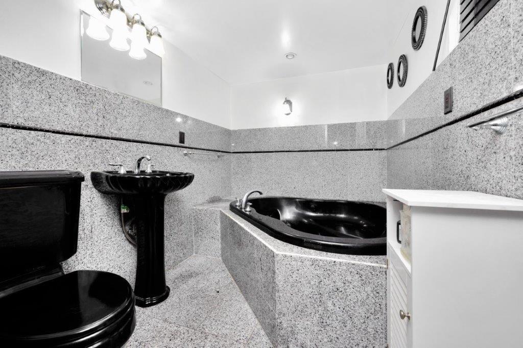 964 Gates Avenue Brooklyn, NY 11221 - Photo 9 of 25 a kitchen with a sink and a stove