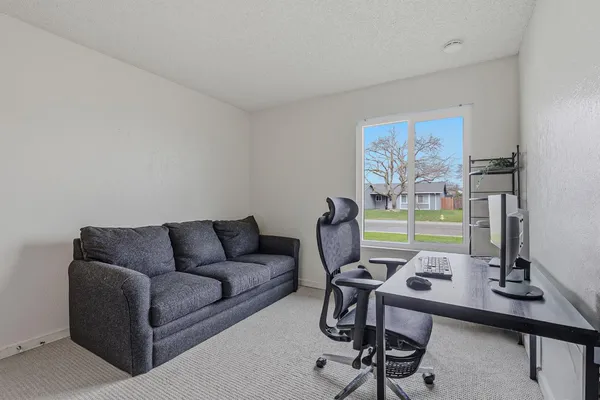 a view of a livingroom with workspace and a couch