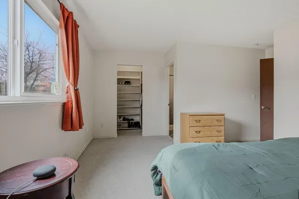a bedroom with a bed and a closet