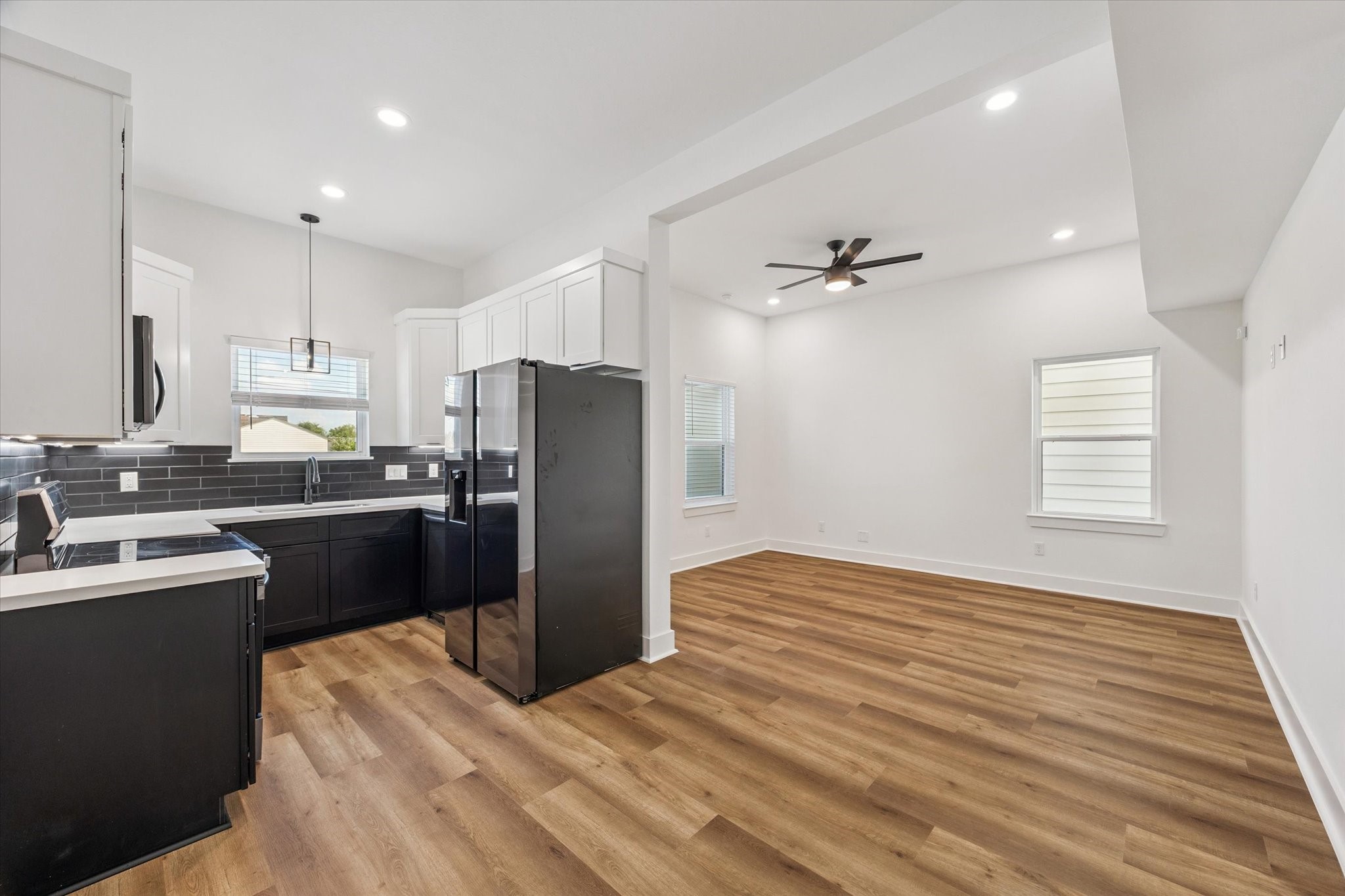 a kitchen with a refrigerator sink and cabinets