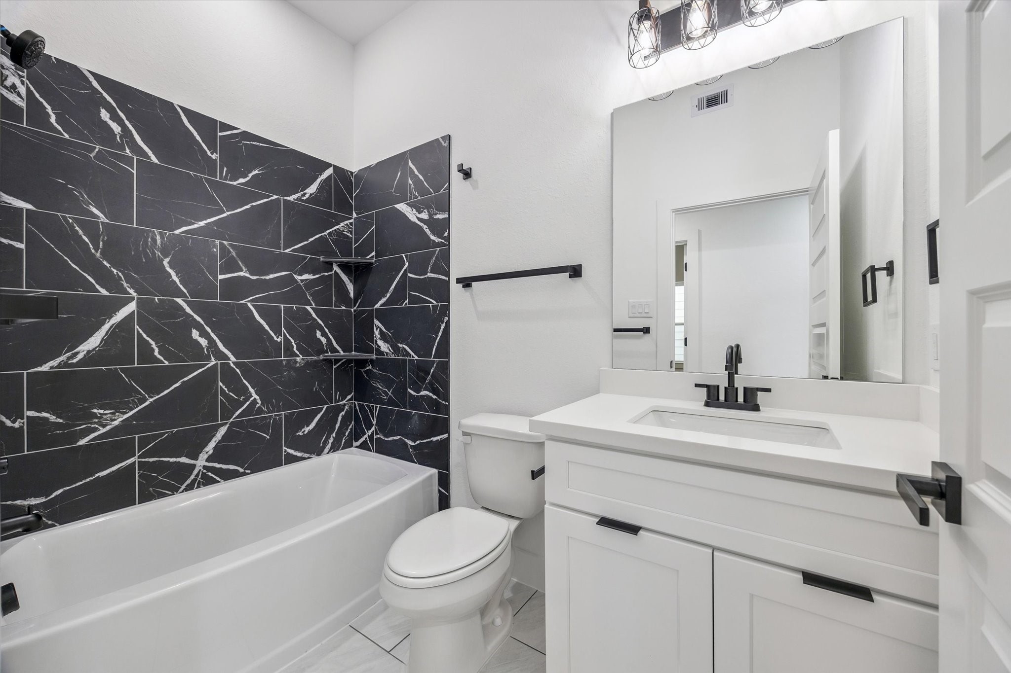 9806 A/B Pelsey Street, Unit A Houston, TX 77029 - Photo 6 of 10 a bathroom with a sink a toilet and a bathtub