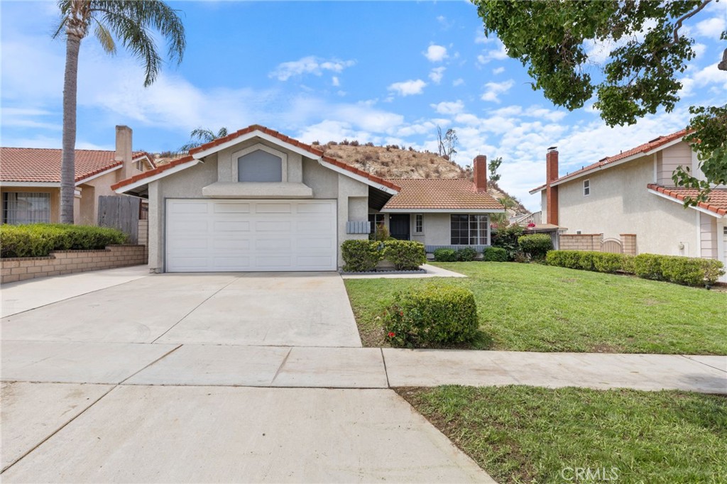 1418 Ripchak Road Corona, CA 92879 - Photo 1 of 1 a view of a white house with a yard and potted plants