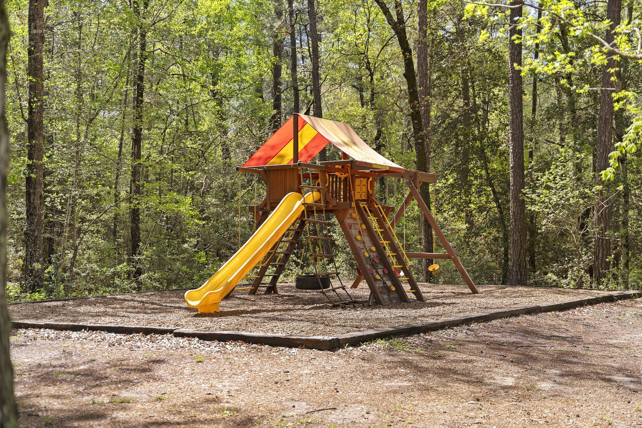 14-15a PROSPERITY Court Huntsville, TX 77340 - Photo 23 of 27 a view of a park with a slide