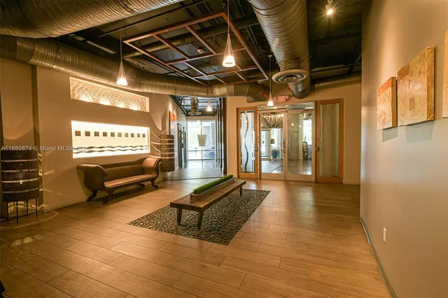 a lobby with glass door and furniture