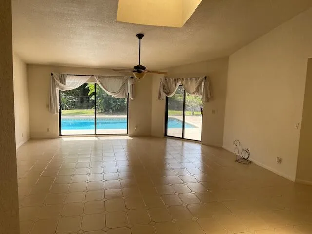 an empty room with windows and outdoor view
