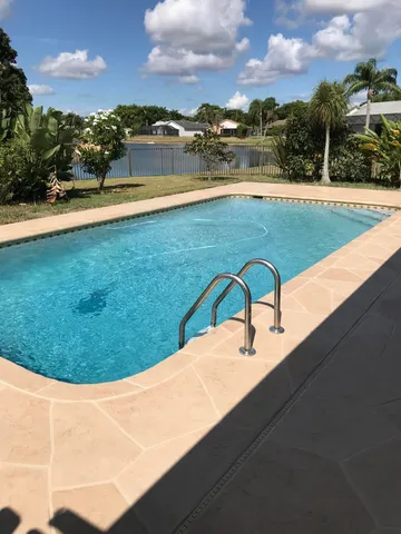 a view of a swimming pool with an outdoor seating