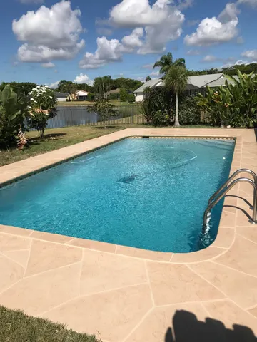 a view of a swimming pool with an outdoor space and seating area