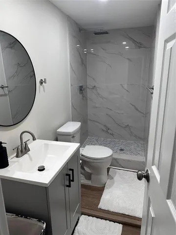 a bathroom with a toilet sink and mirror