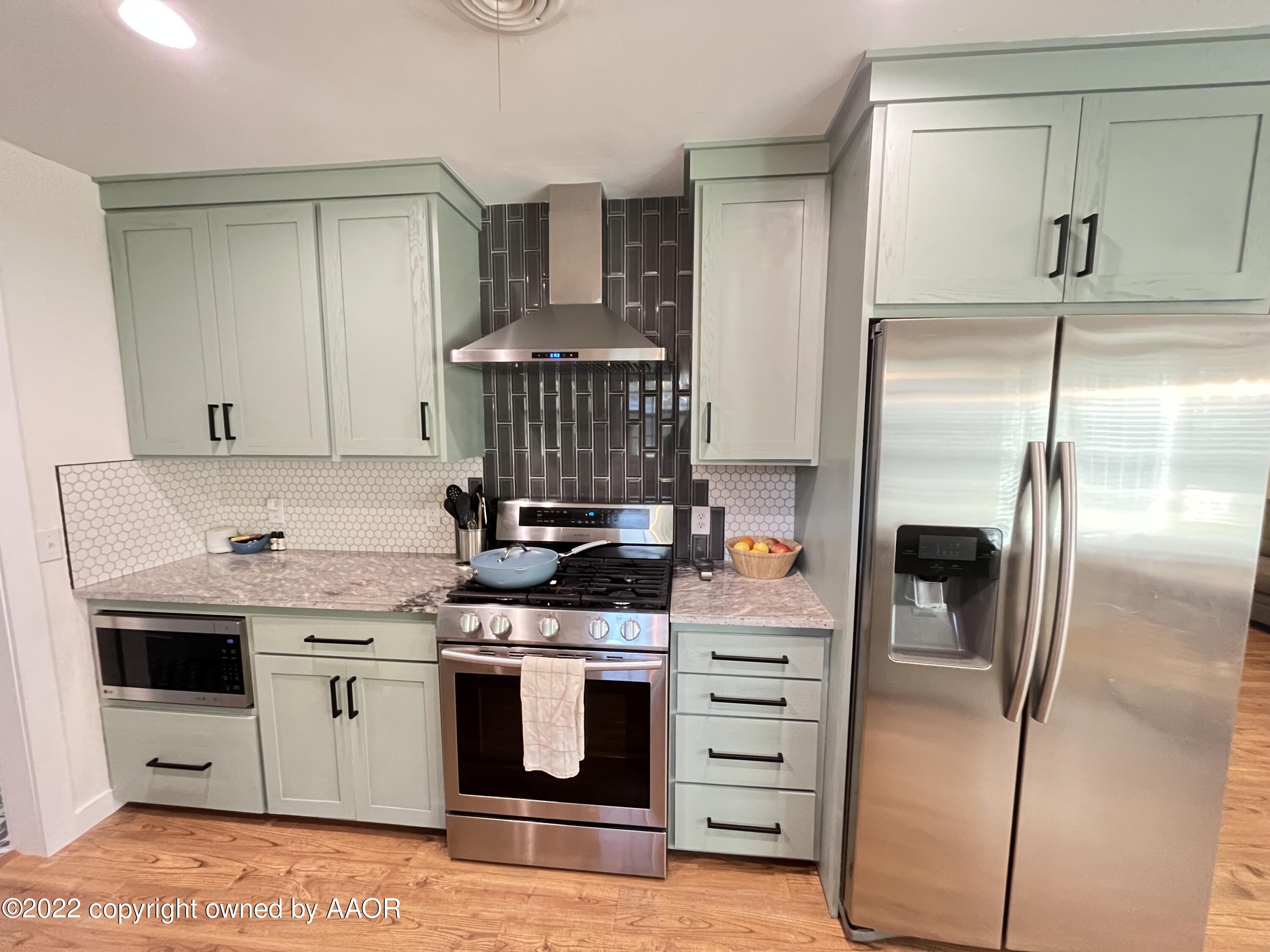6111 Calumet Road Amarillo, TX 79106 - Photo 10 of 34 a kitchen with a stove and a refrigerator