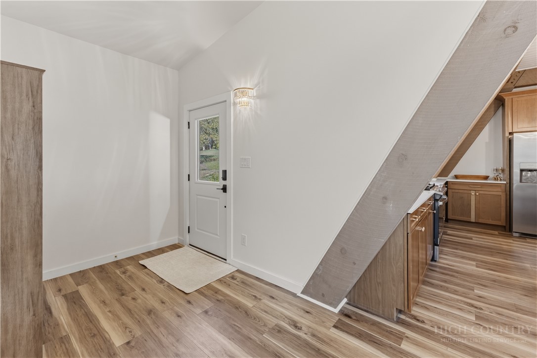 355 South River Hills Road Lansing, NC 28643 - Photo 10 of 45 a view of a hallway with wooden floor and staircase