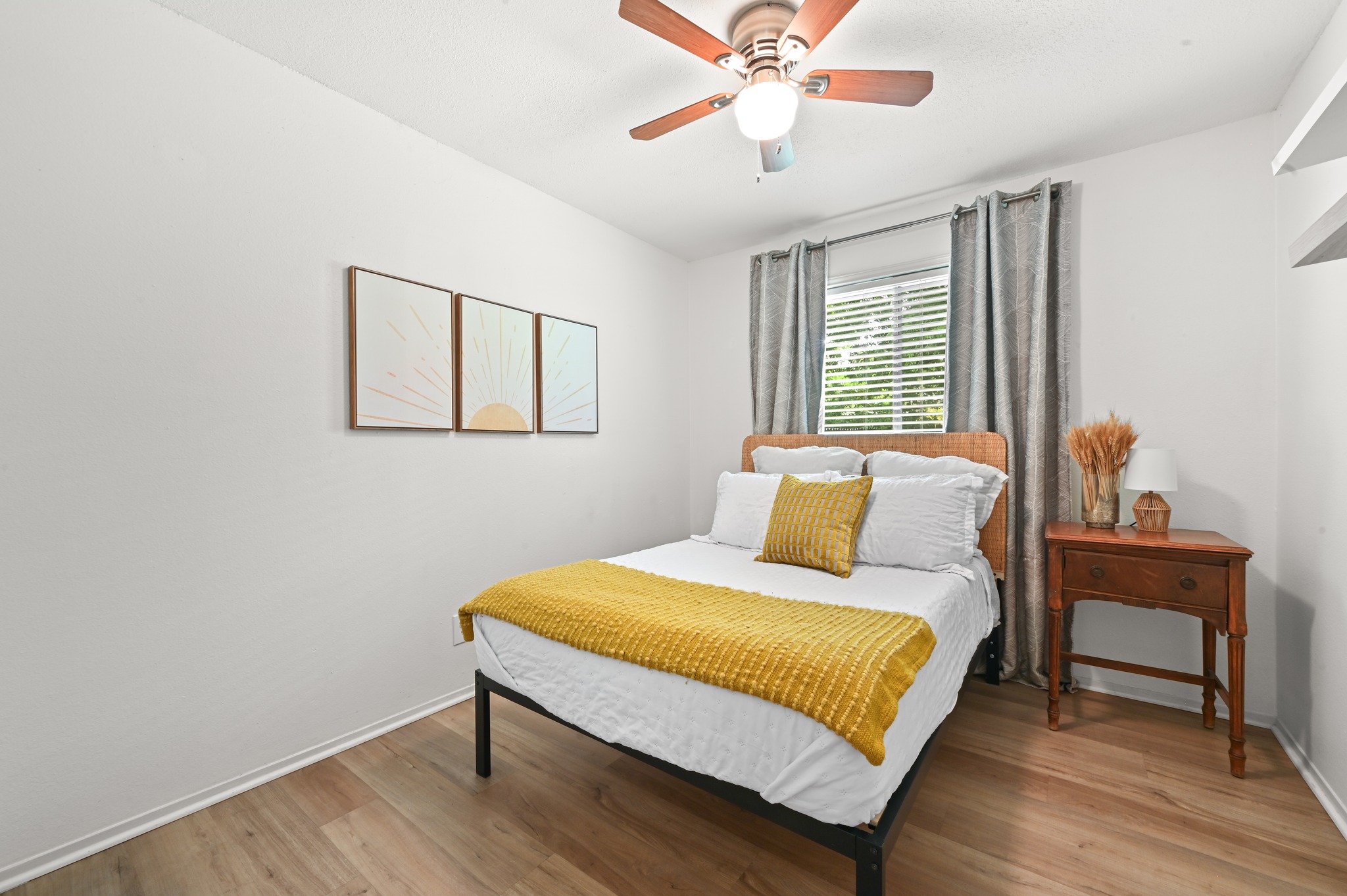6805 Rearden Road Austin, TX 78745 - Photo 18 of 26 Hardwood-style flooring and a ceiling fan provide comfort in this restful bedroom retreat.
