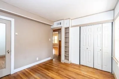 a view of staircase with wooden floor and white walls
