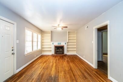 2513 21st Street, Unit FRONT Lubbock, TX 79410 - Photo 3 of 19 a view of a livingroom with a fireplace wooden floor and window