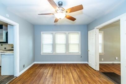 2513 21st Street, Unit FRONT Lubbock, TX 79410 - Photo 6 of 19 a view of an empty room with window and wooden floor