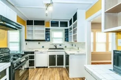 a kitchen with a sink stove and cabinets