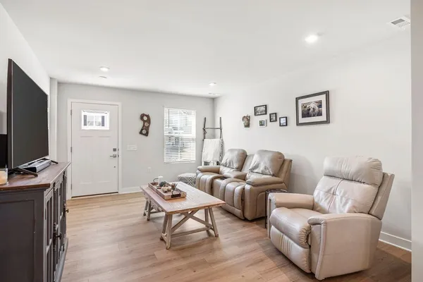a living room with furniture and a flat screen tv