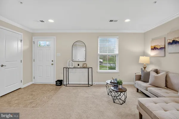 a living room with furniture a window and a table