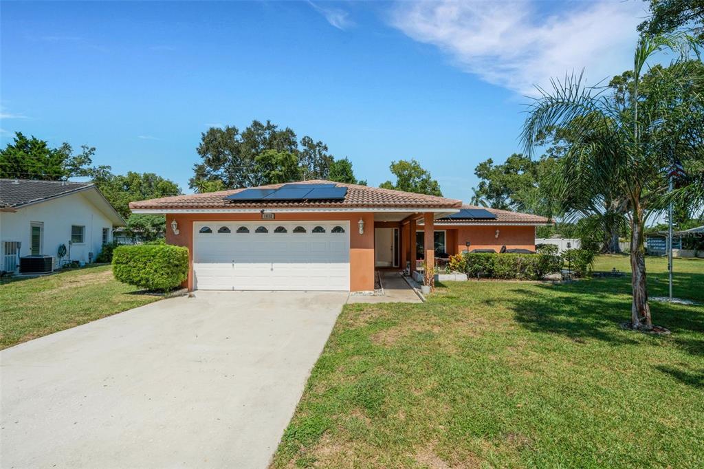 1632 Heather Place Palm Harbor, FL 34684 - Photo 1 of 39 front view of a house with a yard