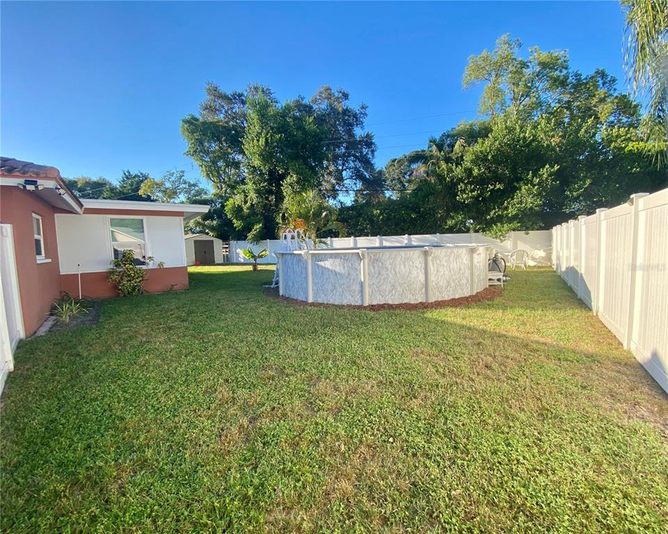 1632 Heather Place Palm Harbor, FL 34684 - Photo 27 of 39 a view of a backyard with a garden and fire pit