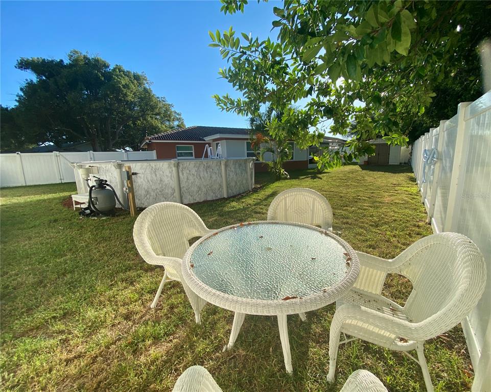 1632 Heather Place Palm Harbor, FL 34684 - Photo 28 of 39 a backyard of a house with table and chairs