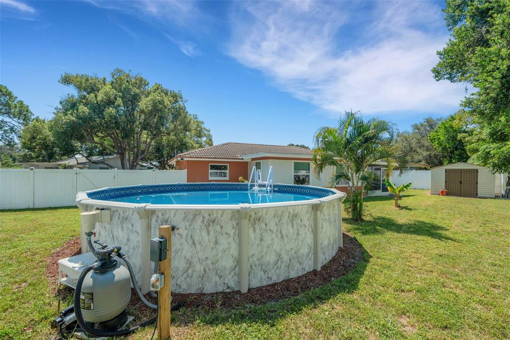 1632 Heather Place Palm Harbor, FL 34684 - Photo 29 of 39 a view of a swimming pool with a yard