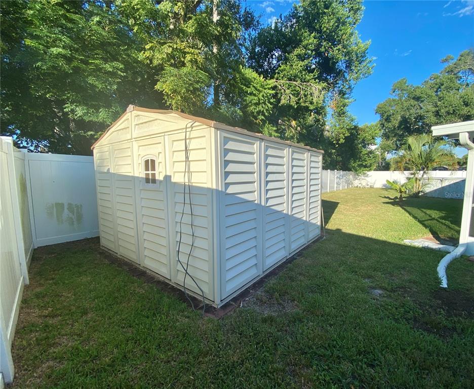 1632 Heather Place Palm Harbor, FL 34684 - Photo 31 of 39 a view of a backyard with wooden fence