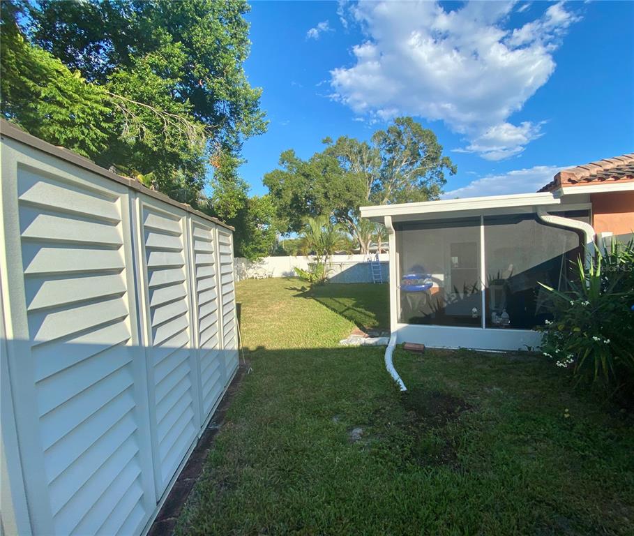 1632 Heather Place Palm Harbor, FL 34684 - Photo 32 of 39 a view of a house with backyard and a garden