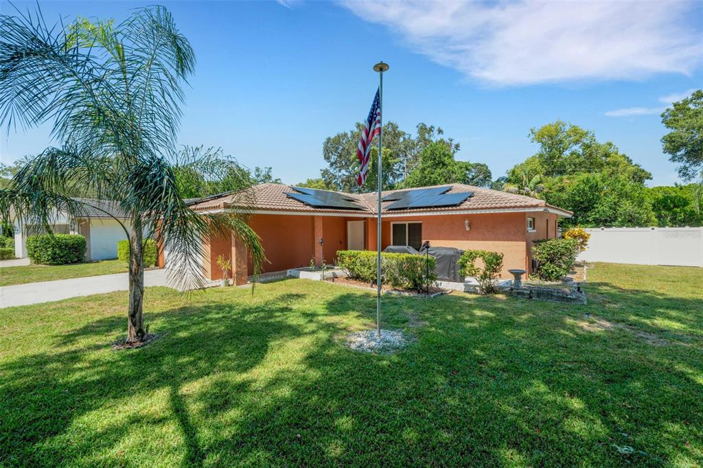 1632 Heather Place Palm Harbor, FL 34684 - Photo 33 of 39 a front view of house with a garden