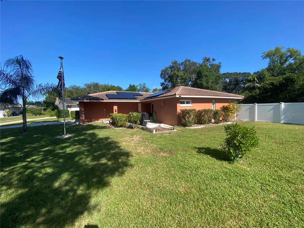 1632 Heather Place Palm Harbor, FL 34684 - Photo 34 of 39 a view of an house with backyard space and garden
