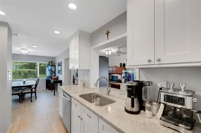 a kitchen with sink refrigerator and cabinets