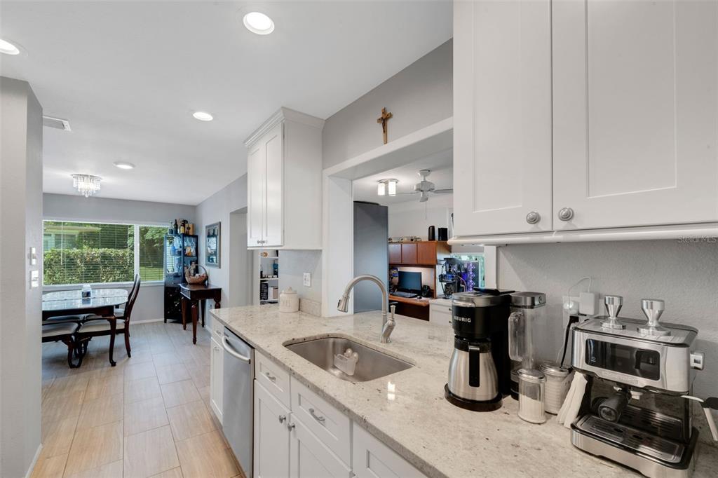 1632 Heather Place Palm Harbor, FL 34684 - Photo 8 of 39 a kitchen with sink refrigerator and cabinets