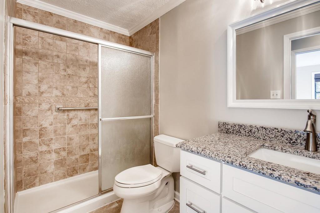 2274 Turtle Landing Marietta, GA 30066 - Photo 13 of 28 a bathroom with a granite countertop sink toilet and shower