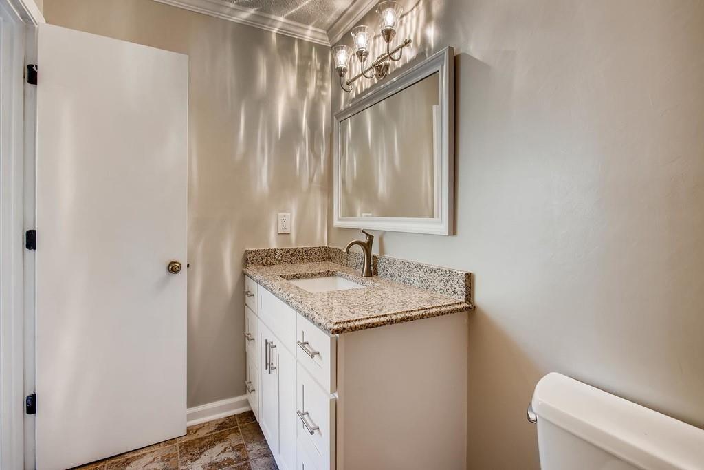 2274 Turtle Landing Marietta, GA 30066 - Photo 17 of 28 a bathroom with a granite countertop sink and a mirror